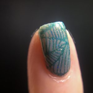 Close up on a single stamped nail - it looks so different straight on the base colour.