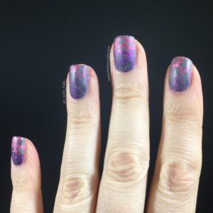 Right hand fingers upright on black background with grey, pink and purple nail art design