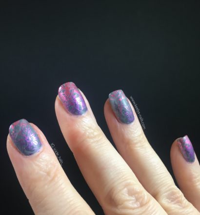 Right hand fingers on a black background with grey matte nails with a pink and purple gradient stamping design