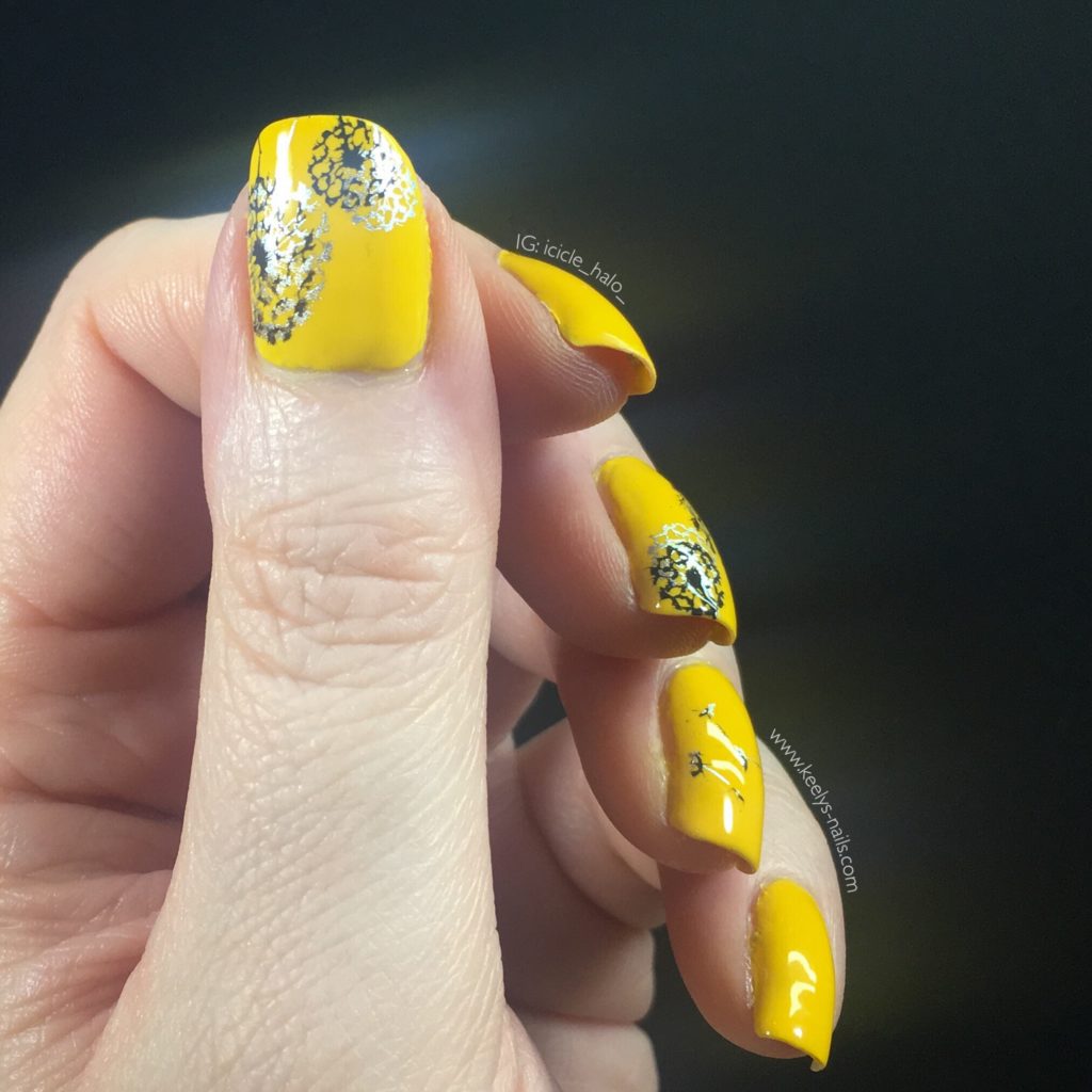 Stamped nail art in silver and black is an unusual colour combination with the bright yellow