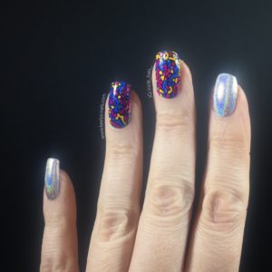 Fingers on a black background with silver holo nails and Millefiori inspired nail art
