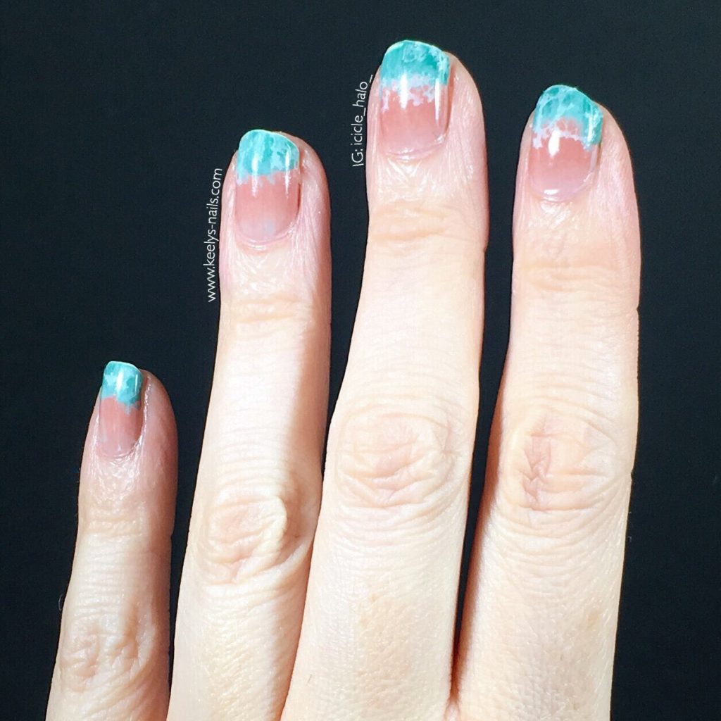 Left hand fingers pointing up on a black background. Nails with a pale pink gradient and a turquoise waves design at the tips.