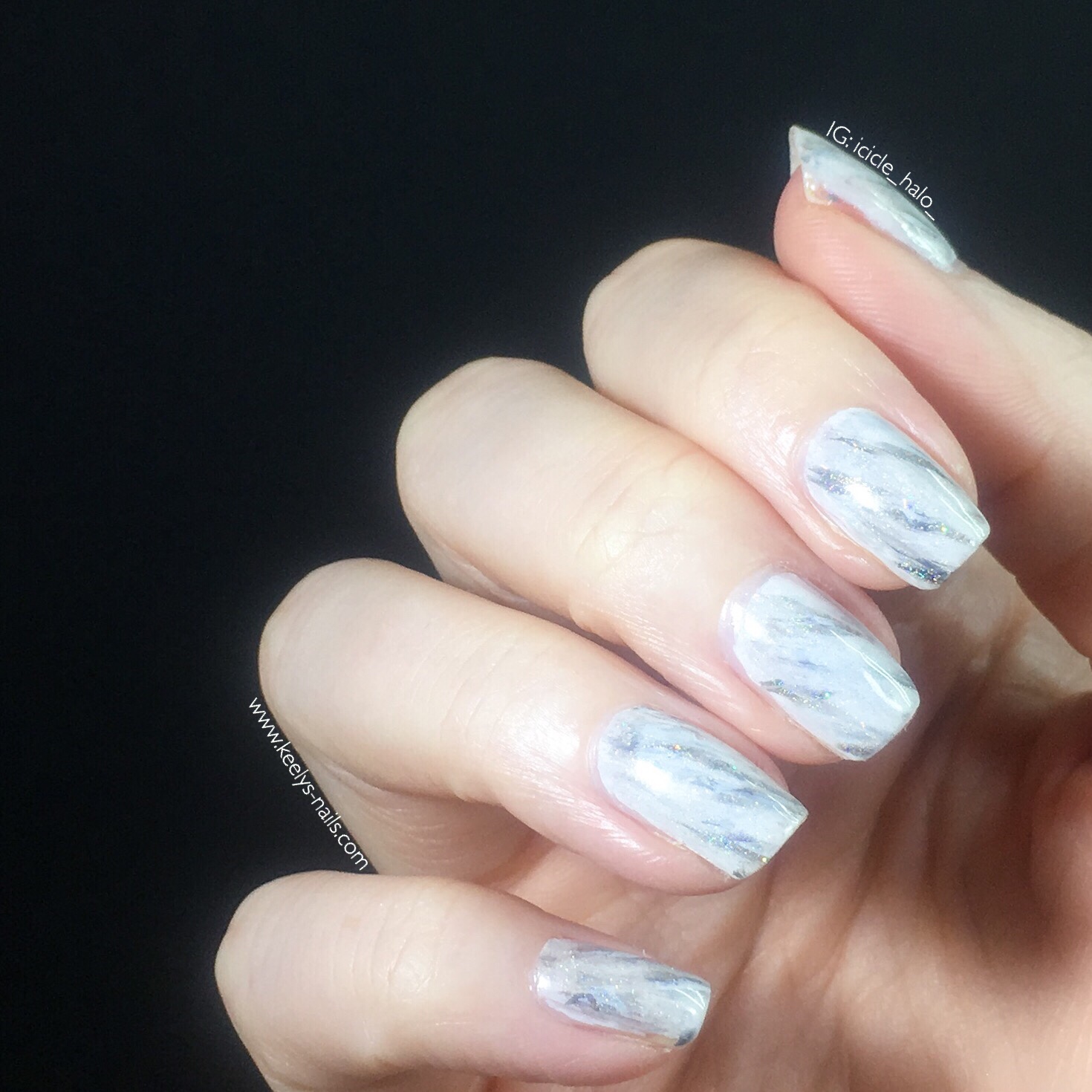 Right hand featuring white marble nail art